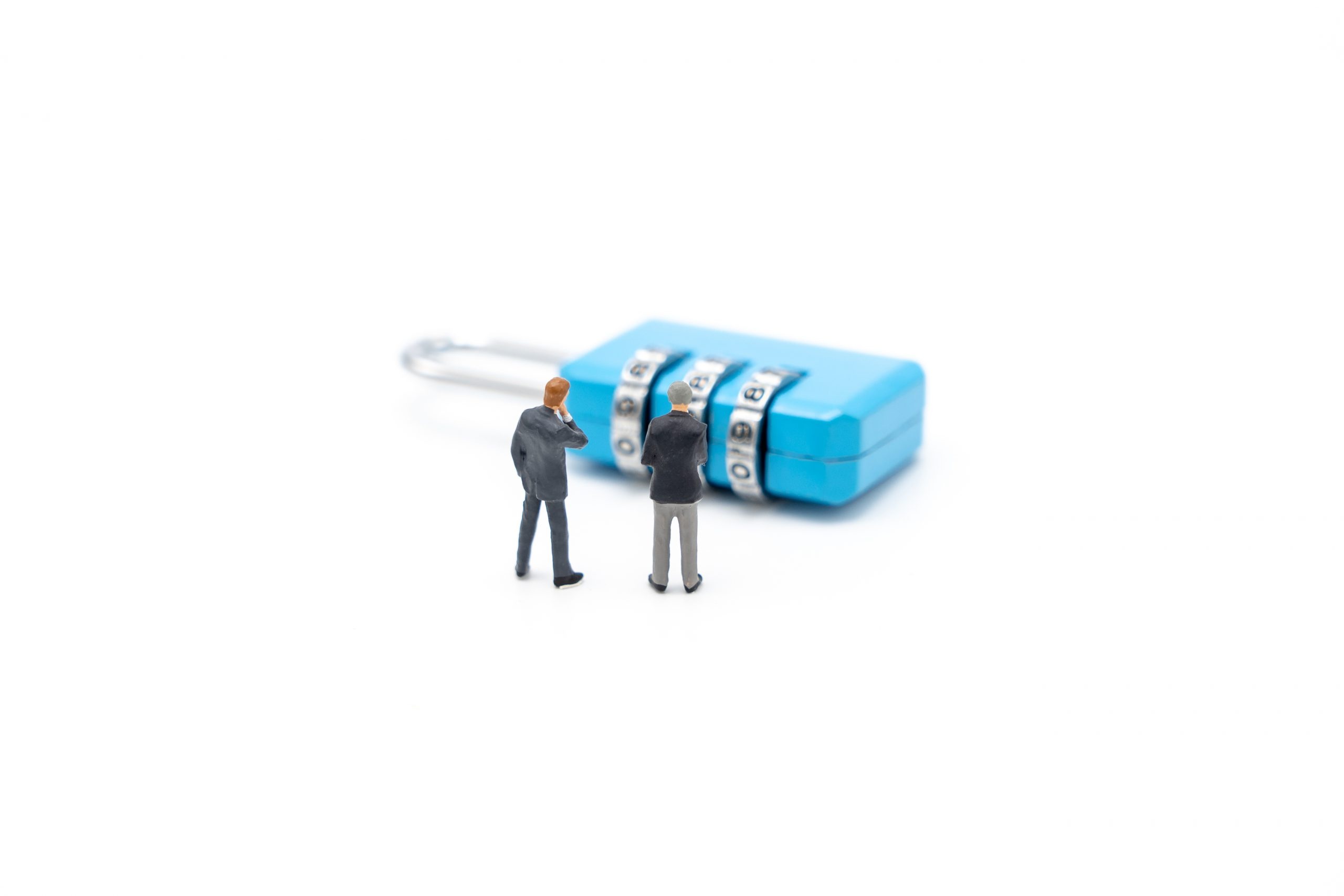 Miniature people businessmen analyze password From the blue key as background business concept and Security concept with copy space.