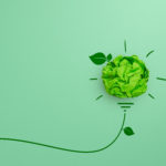 Green crumpled paper light bulb on green background, Corporate Social Responsibility (CSR), eco-friendly business and environmental concept