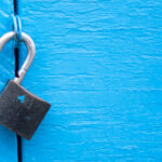 Open lock on blue door background - template for text security b
