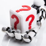 Robot Holding Cubic Block With Question Mark Sign
