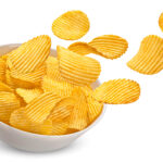 Ridged potato chips in bowl isolated on white background