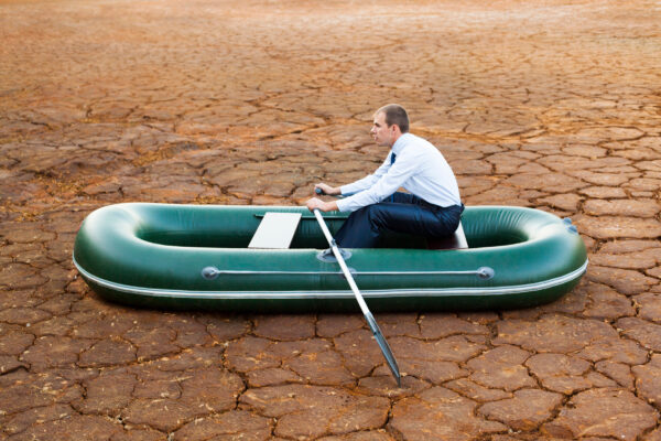 businessman in boat rocks looks bright future symbol crisis stag