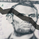 Arrow down on the background of dollar bill. The concept of inflation, depreciation of the dollar or the US economy.