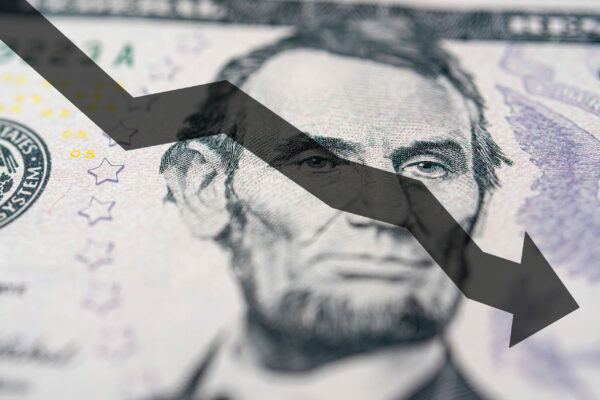 Arrow down on the background of dollar bill. The concept of inflation, depreciation of the dollar or the US economy.