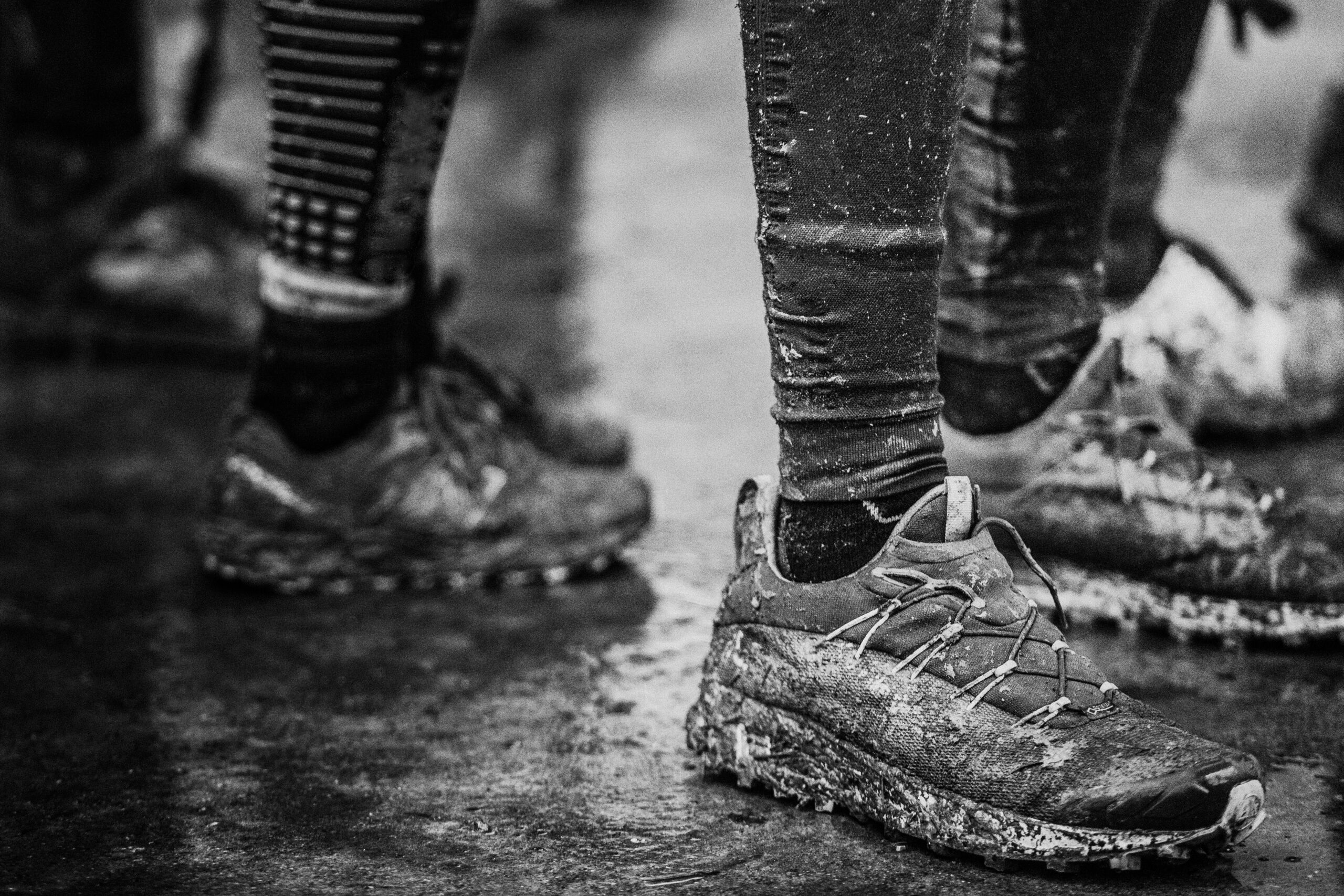 Black and white muddy dirty shoes after trail running run