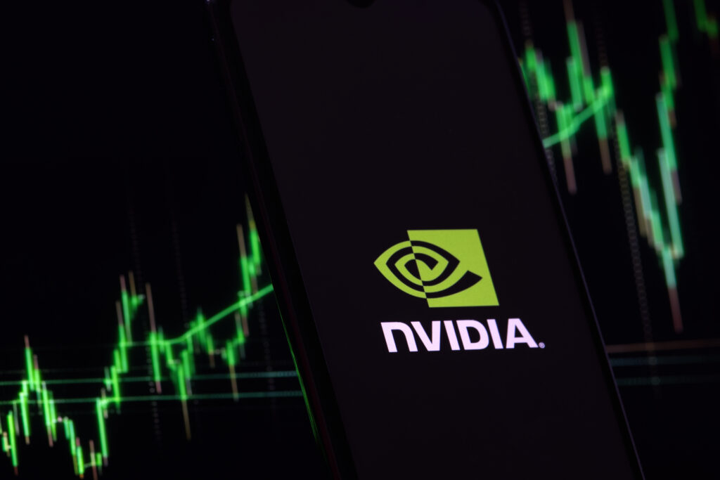 Nvidia investment growth and profit trading concept. Nvidia company logo on screen of smartphone against blurred background of up trading stock chart.