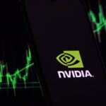 Nvidia investment growth and profit trading concept. Nvidia company logo on screen of smartphone against blurred background of up trading stock chart.