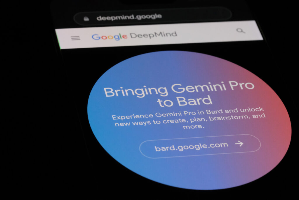 A smartphone screen shows the Google DeepMind website featuring a blue promotional banner for 'Gemini Pro to Bard' with text inviting users to explore new creative and planning tools on 'bard.google.com.