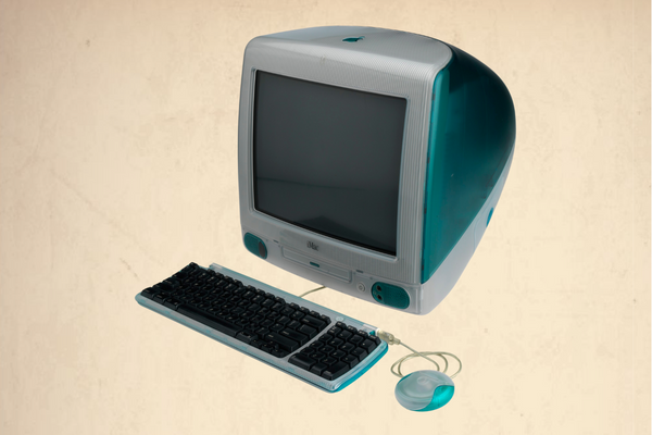 This image showcases the iMac G3, Apple's iconic all-in-one personal computer notable for its translucent, colorful design and curvy shell.