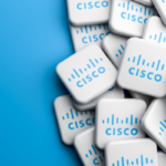 A pile of white key-shaped promotional items with the Cisco logo on a blue background.