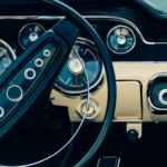 Retro styled image of an old classic sports car dashboard with black and white interiors.