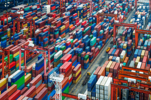 An overhead picture of a shipping port with very many shipping containers, representing critical infrastructure.