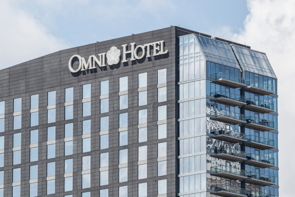 Picture of the outside of an Omni Hotel, with the logo displayed on the building.