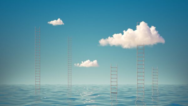 Surreal seascape with ladders in the middle of the sea. Panoramic wallpaper with white clouds in the blue sky above the water.