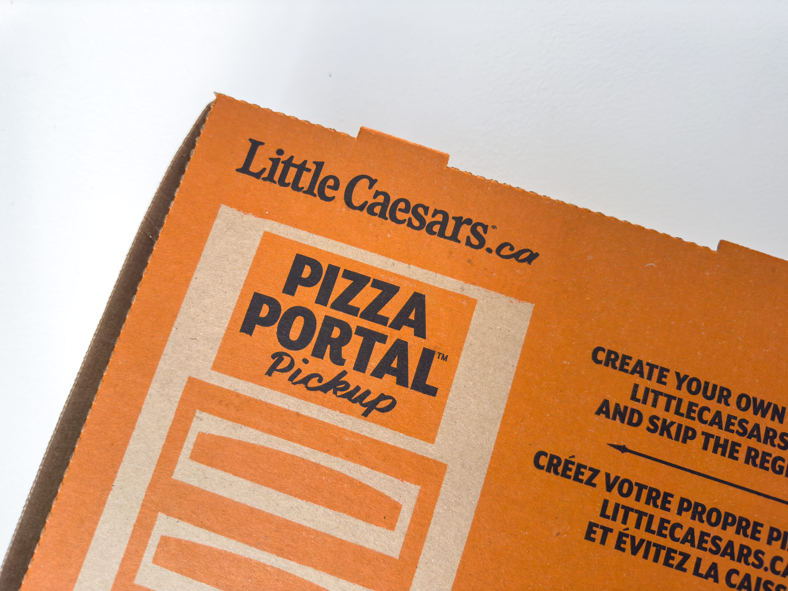 A close up to a Little Caesars pizza box on a white background.