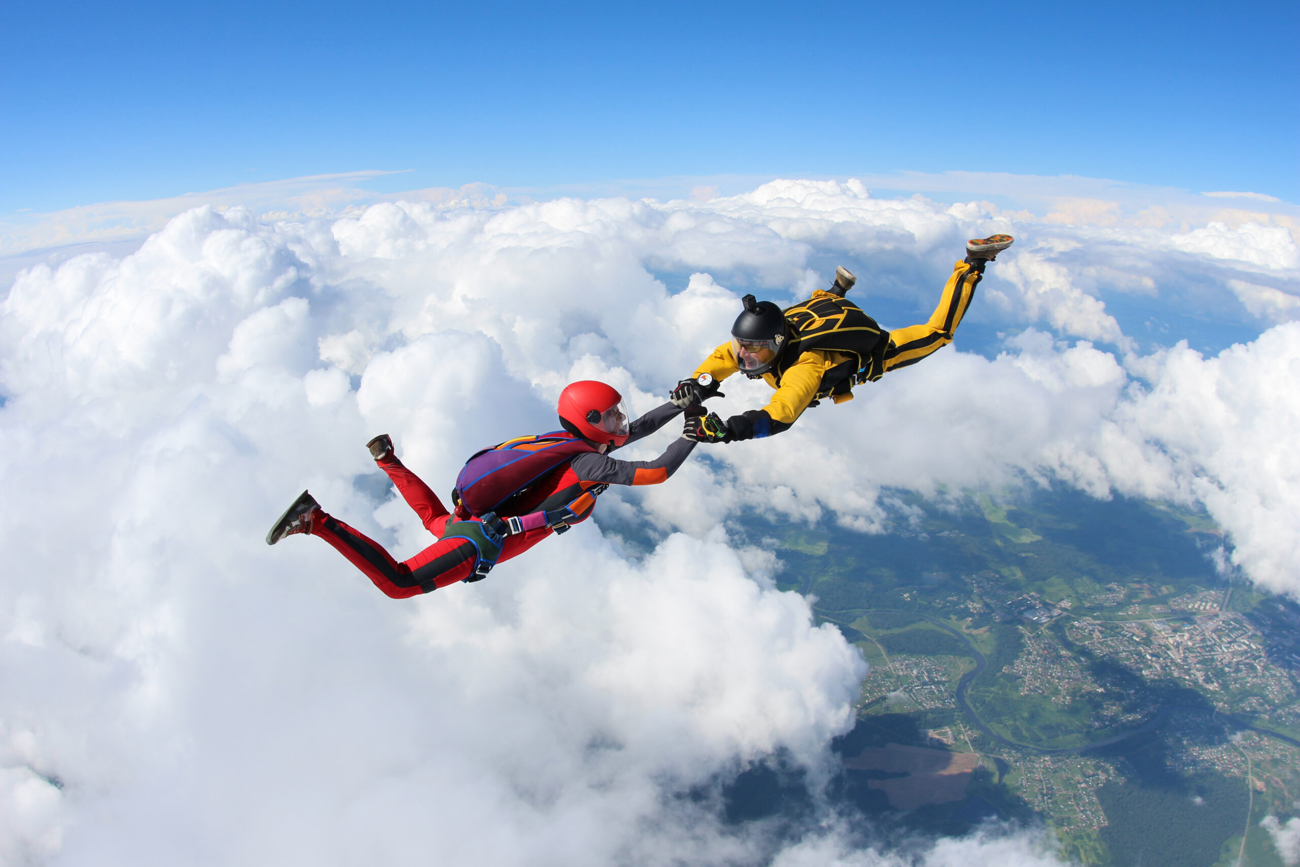 Two skydivers are in the sky.