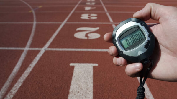 Male hand holding stopwatch with zero time, new life stage beginning fresh start