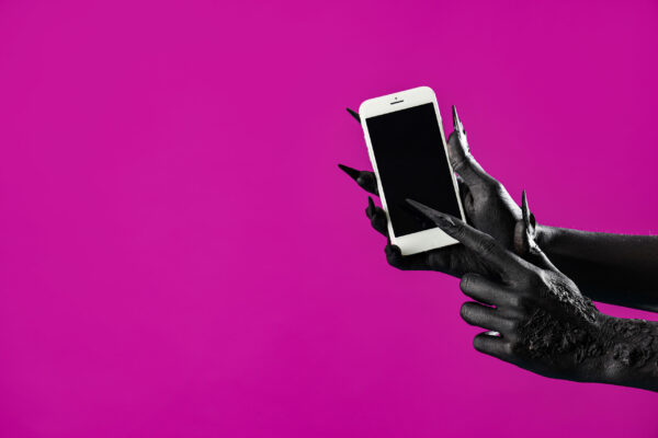 Save to Library Download Preview Preview Crop Find Similar File #: 657368502 Black hands of witch holding mobile phone with blank screen on purple background.