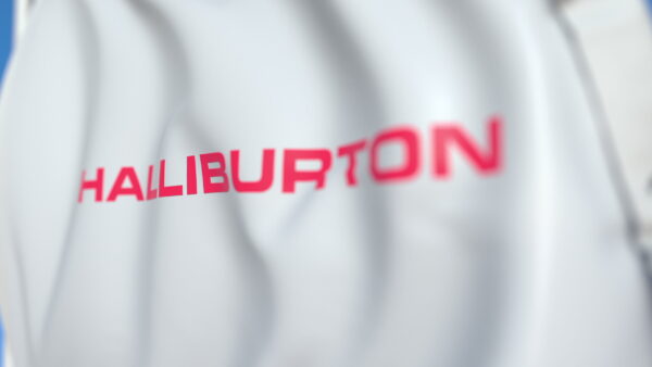 Waving flag with Halliburton logo, close-up.