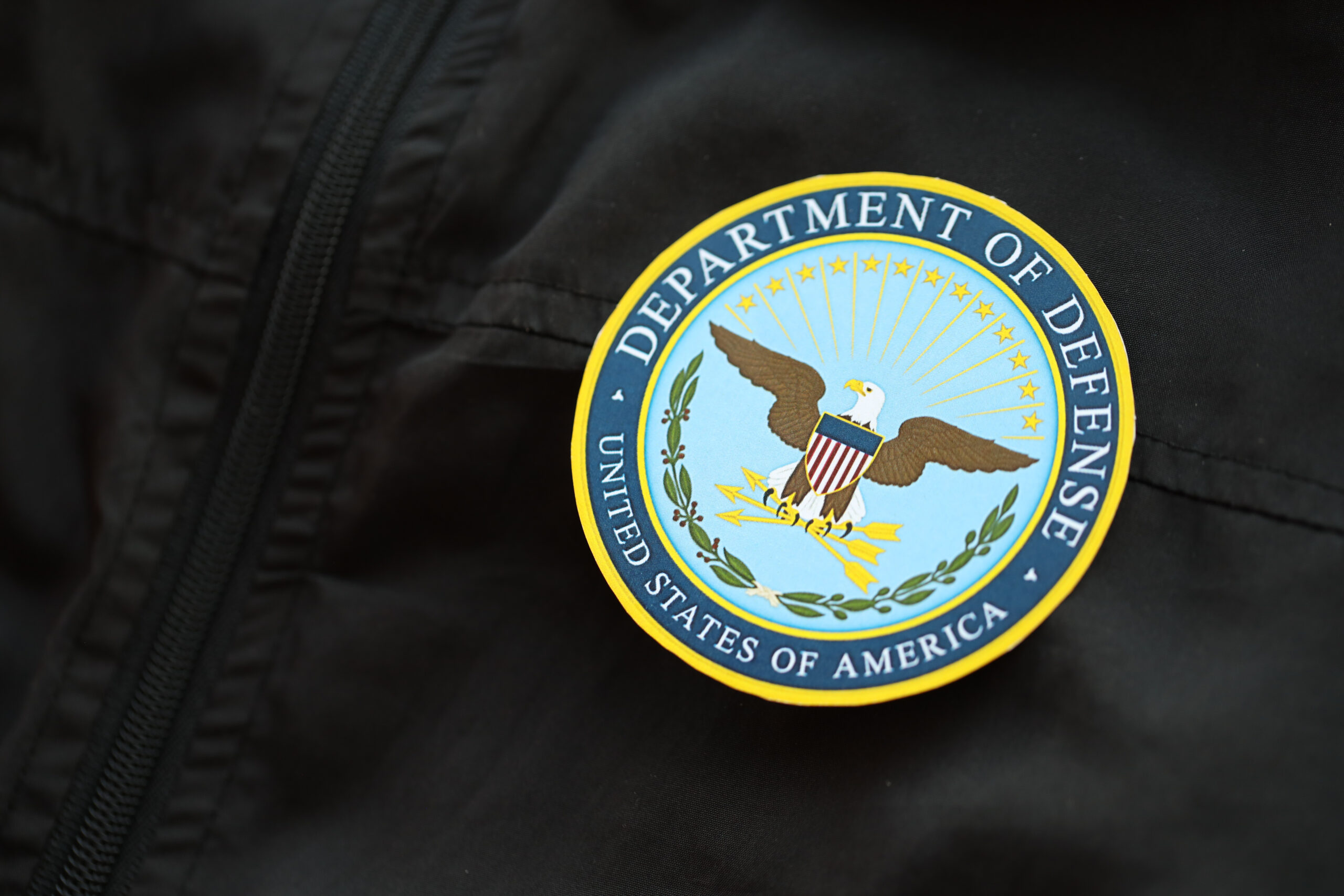 KYIV, UKRAINE - MARCH 9, 2024 US Department of Defense seal on black jacket uniform close up