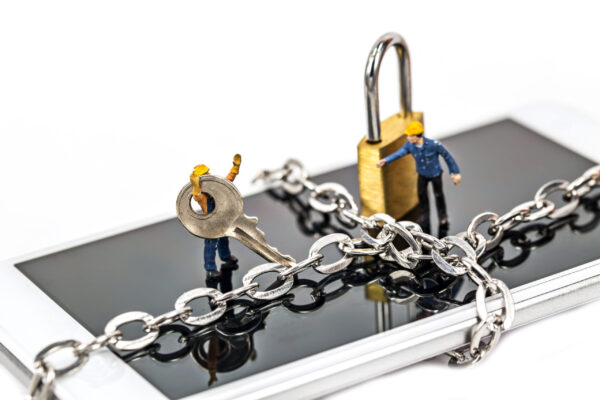 Miniatures on smart phone with chain lock,abstract background for solution to security smart phone form not owner.