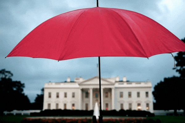 Red umbrella covering white house