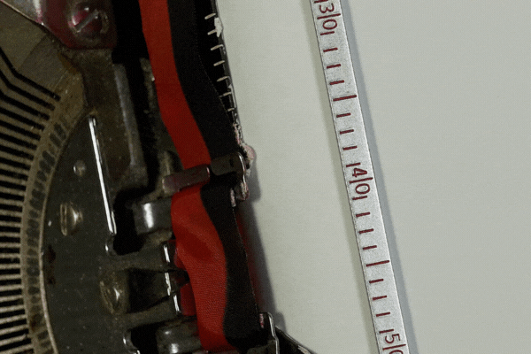 Zoom and turn in to typing RESIGNATION on an old manual typewriter.