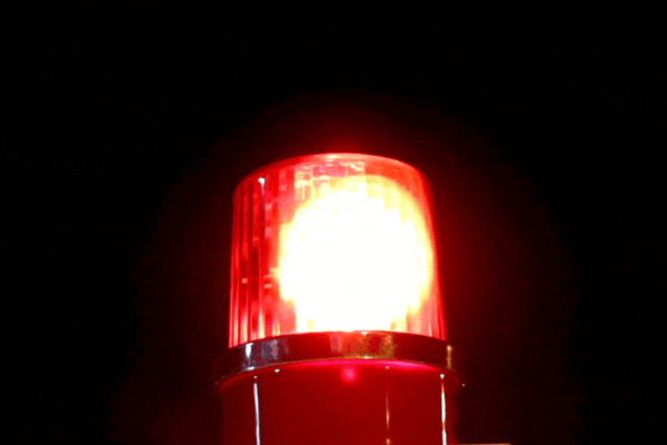 hd video of a alarm light on dark background