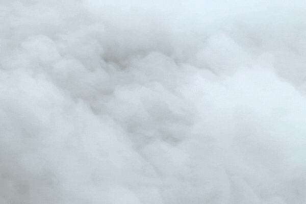 white smoke spreads on the floor Closeup. The texture of dense smoke in the wind close-up. Realistic fog background. Real dry ice clouds close-up