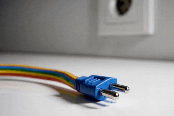 A multicolor cord unplugged from the outlet.