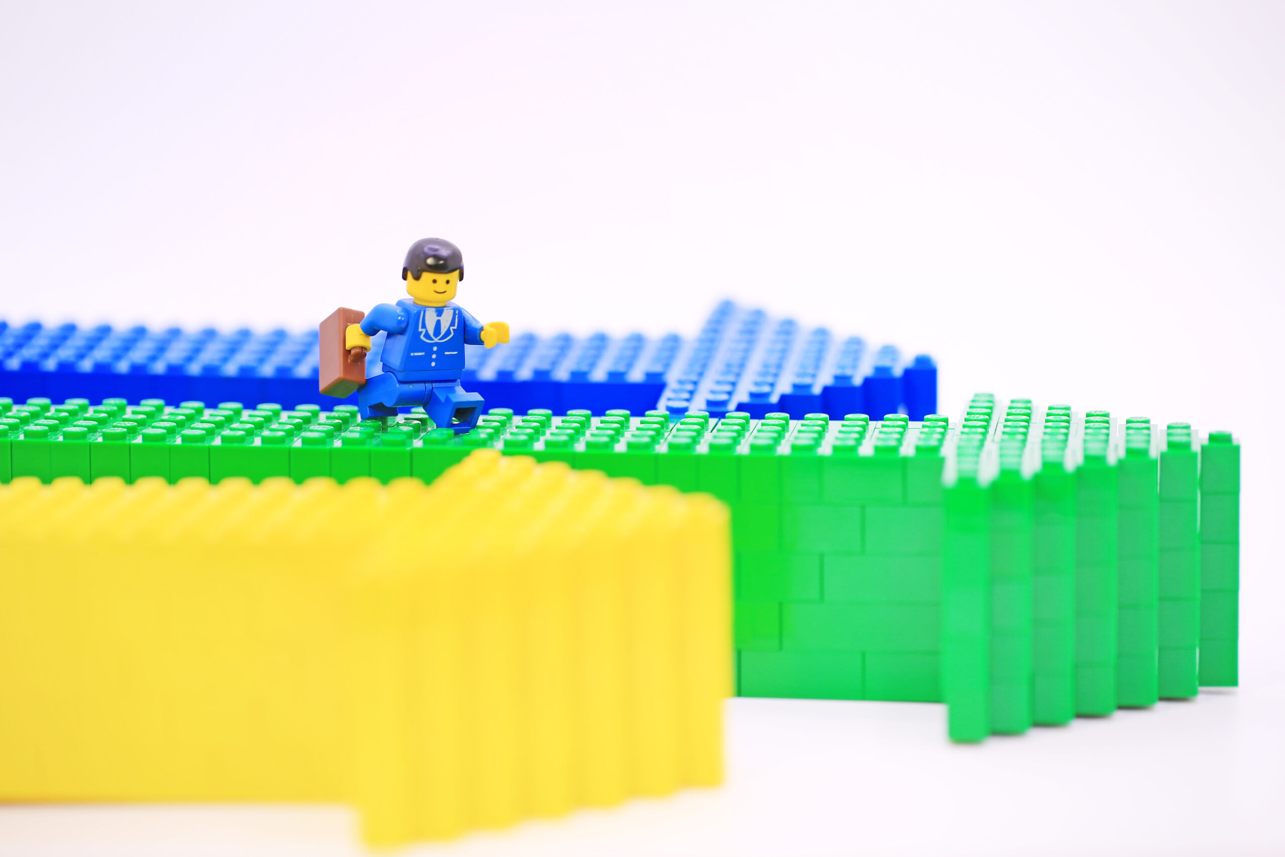 the Lego mini characters is walking on the arrow