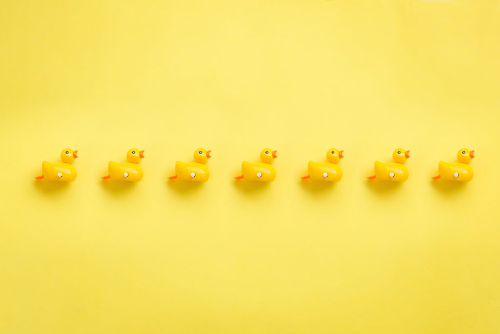 A roll of yellow duckies on yellow background,
