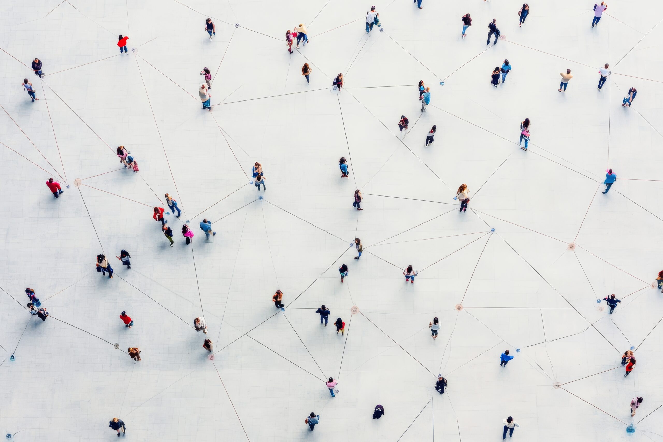 Aerial view of people connected by lines on a white surface.