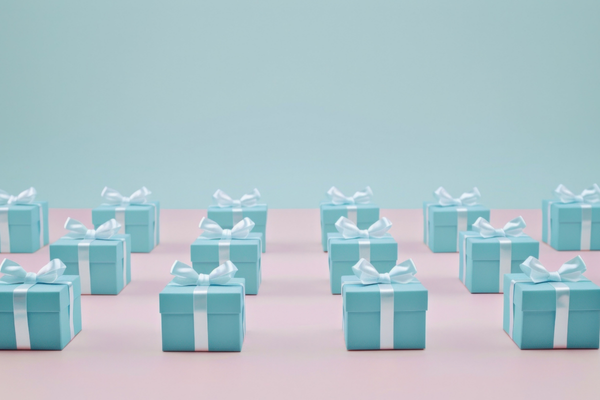 Tiffany blue gift boxes on pink background with copy space for fashion and beauty celebrations and events
