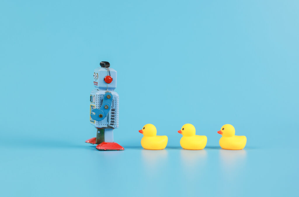 vintage retro robot and Yellow Rubber Bath Ducks, leadership concept.