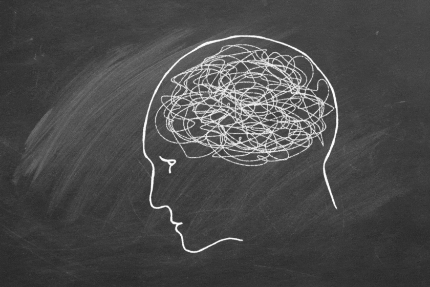 Silhouette of human head with tangled line inside instead of a brain.