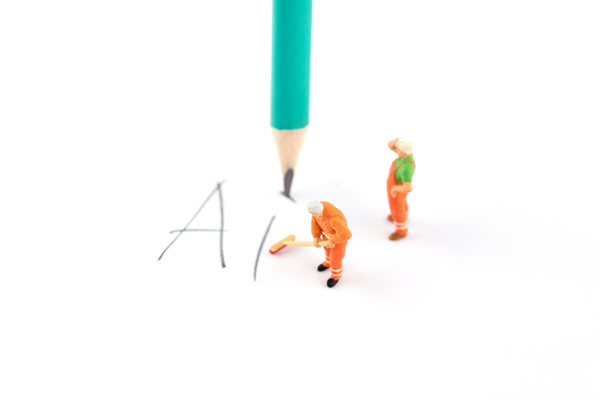 Miniature creative pencil writing AI artificial intelligence