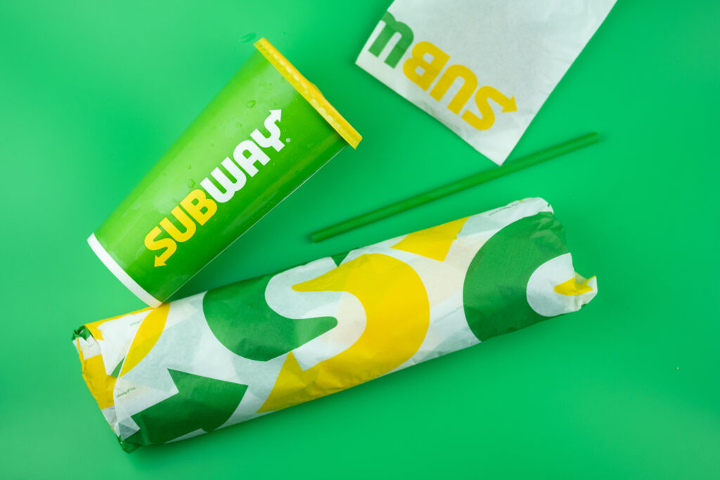 Bangkok, Thailand - December 13, 2020 : Close up set of takeaway sandwiches from Subway restaurant on green background.