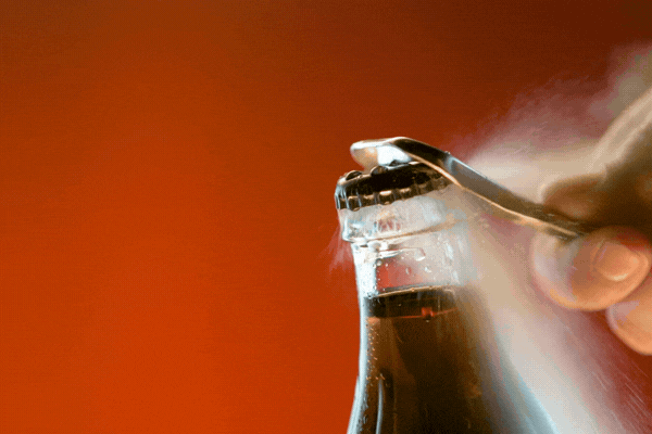 Opening glass bottle in slow motion. Fizz and bubbles. Phantom 4k camera