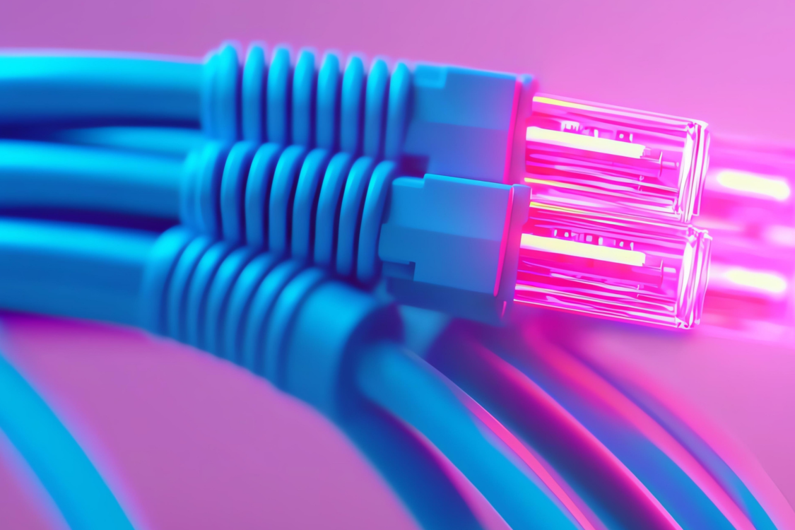 Colorful network cables against a pink background.