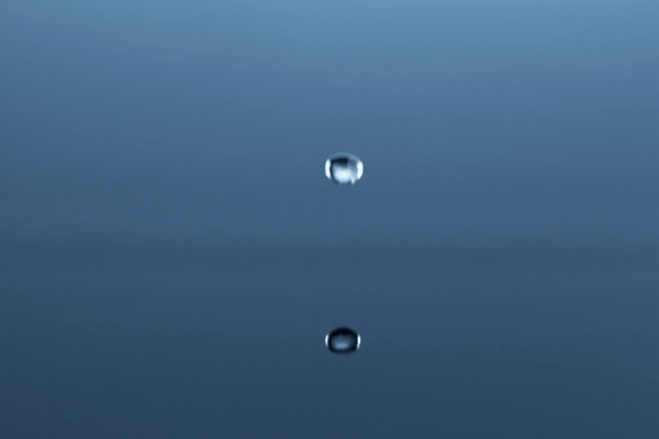 Super slow motion of dripping water drop filmed with macro lens. Filmed on high speed cinema camera, 1000 fps.