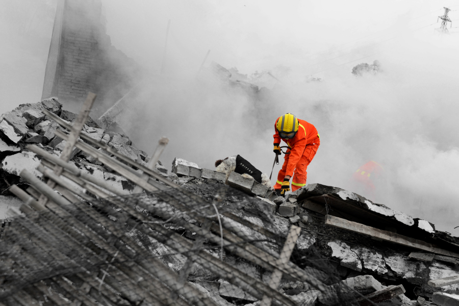 Search and rescue forces search through a destroyed building FEMA