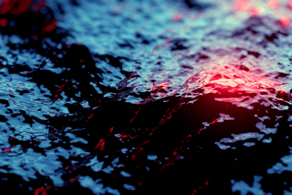 Dark Ocean Surface With Red Warning Lights