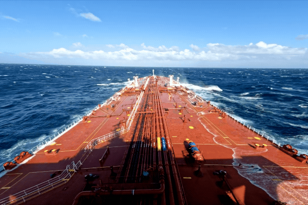 View from the deck of an oil tanker traveling through open ocean waters.
