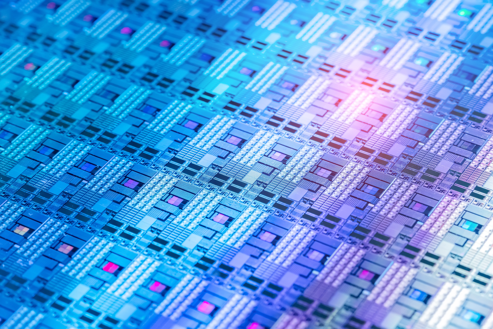 Close-up of a semiconductor chip with blue and purple circuitry.