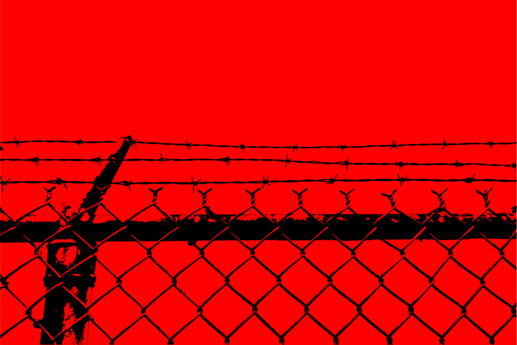 Black chain-link fence topped with barbed wire against a bright red background.