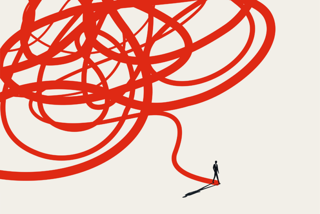 Silhouette of a businessman walking away from a giant tangled red knot onto a straight clear path.