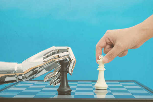 Human playing chess with robot